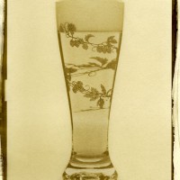 Van Dyke Brown Printing of a glass of beer. The glass has a hop motif, a vine of hops wrapping around the body.